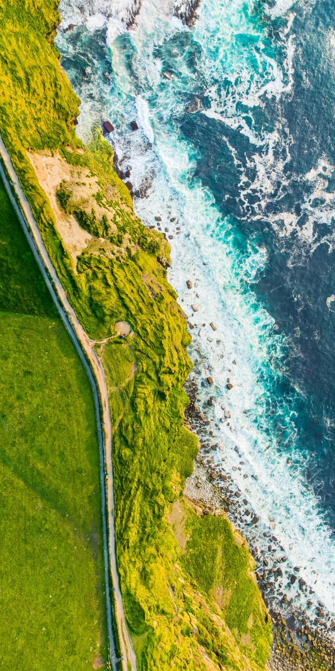image of ocean and green fields