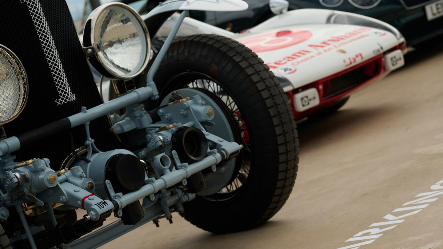 Two vintage cars parked together